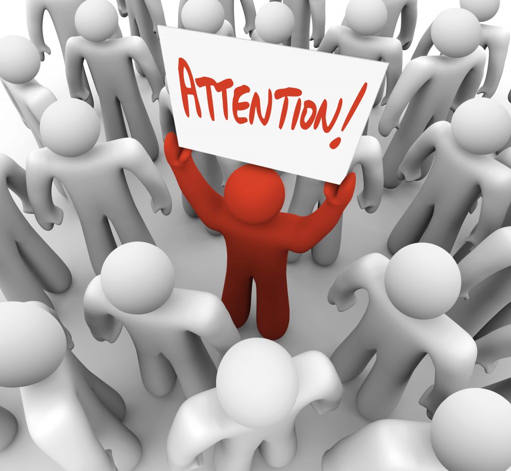 A,Red,Person,Stands,Out,In,A,Crowd,Holding,A